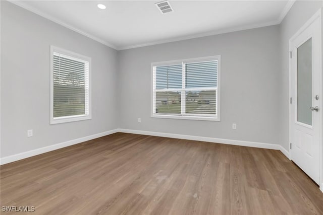 unfurnished room featuring a healthy amount of sunlight, baseboards, and visible vents