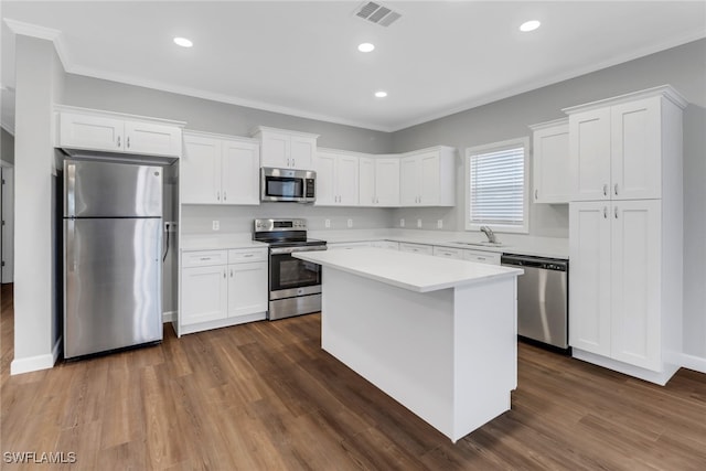 837 Da Vinci Ave S, Lehigh Acres, FL 33974 - kitchen with a kitchen island, visible vents, white cabinets, light countertops, and appliances with stainless steel finishes