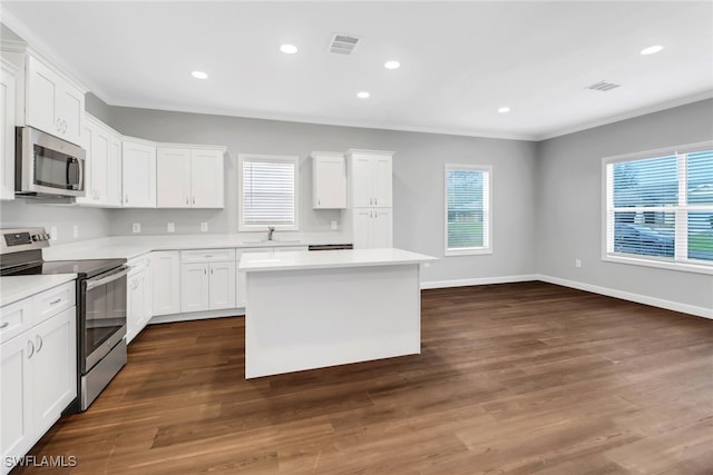 kitchen featuring white cabinets, visible vents, stainless steel appliances, and light countertops