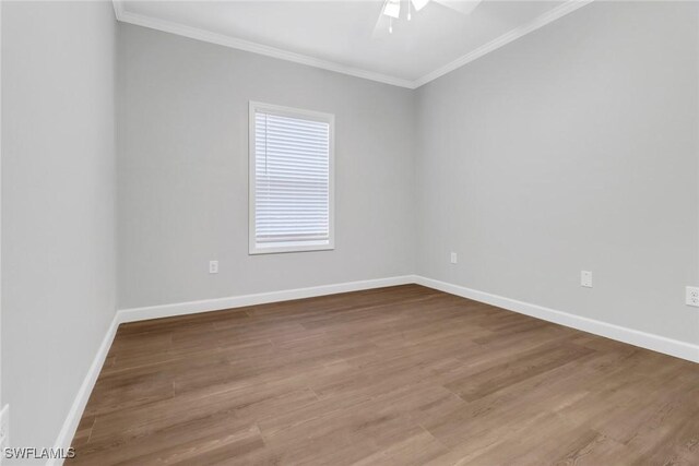 837 Da Vinci Ave S, Lehigh Acres, FL 33974 - unfurnished room featuring baseboards, wood finished floors, a ceiling fan, and crown molding