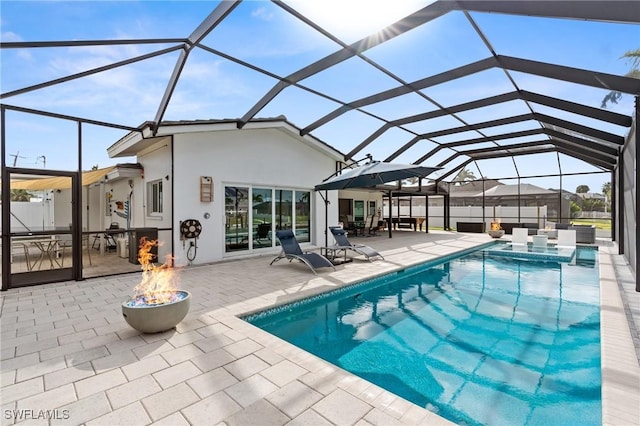 view of swimming pool featuring a patio and a lanai