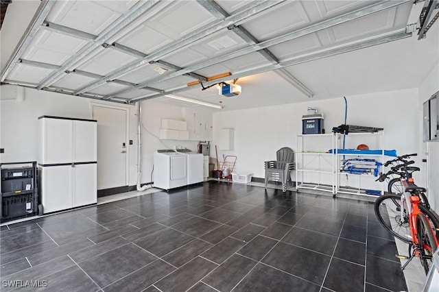 garage featuring washer and clothes dryer and a garage door opener