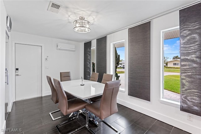 dining space featuring plenty of natural light, a wall mounted AC, and a notable chandelier