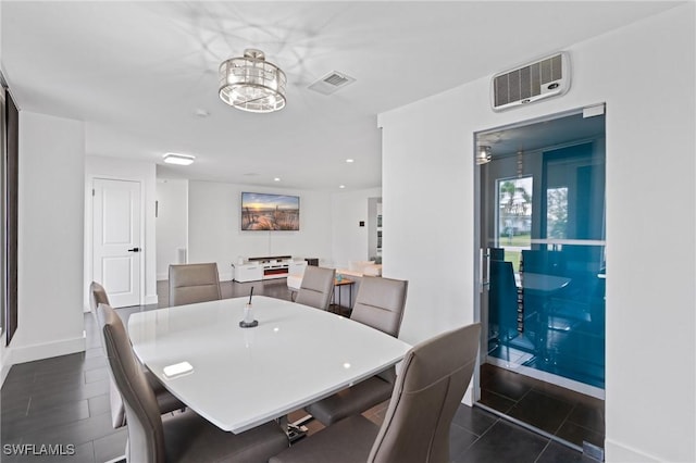 dining area featuring dark tile patterned floors