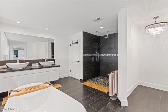 bathroom with vanity and separate shower and tub