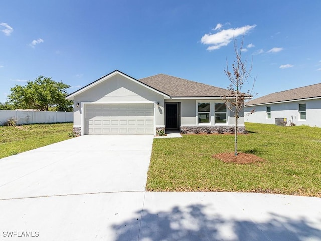 ranch-style home featuring a garage, central AC, and a front lawn