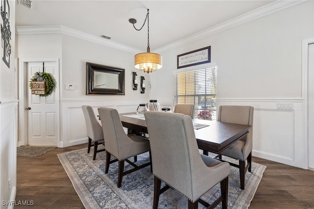 dining area featuring ornamental molding and dark hardwood / wood-style floors