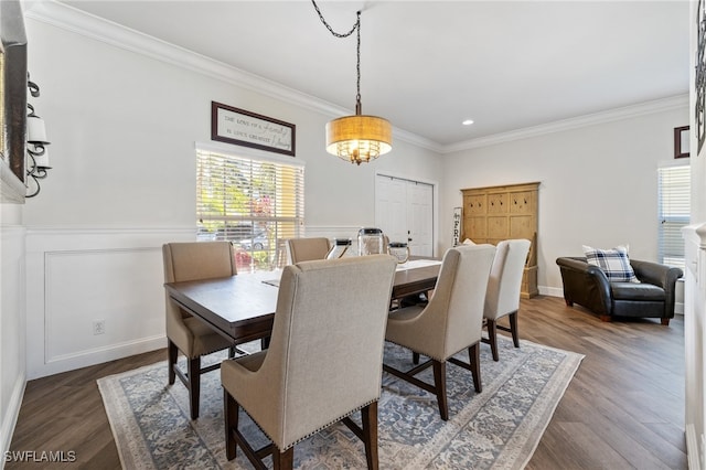 dining room with dark hardwood / wood-style floors and crown molding