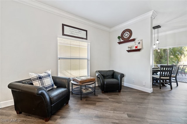 sitting room with crown molding and dark hardwood / wood-style floors