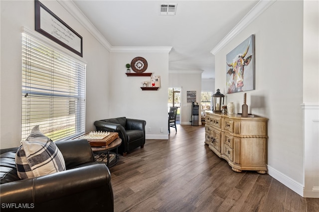 living area with dark wood-type flooring and ornamental molding