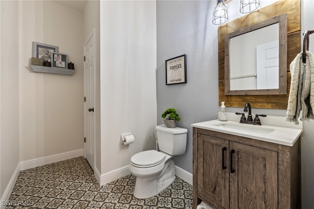 bathroom featuring toilet, tile patterned floors, and vanity