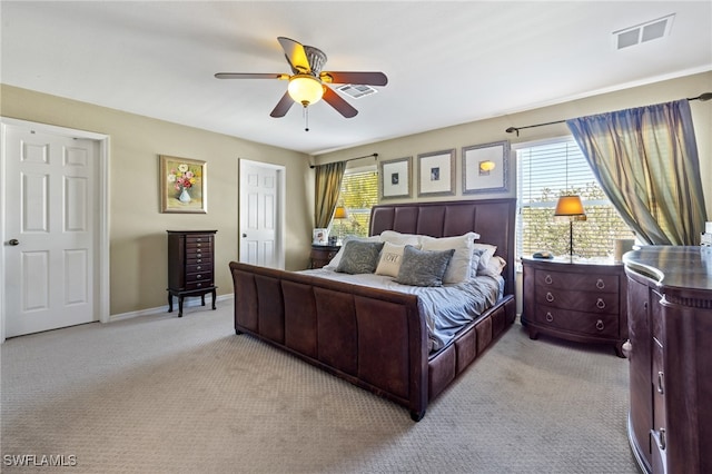 bedroom featuring ceiling fan and light carpet