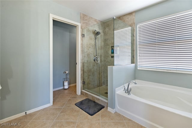 bathroom with separate shower and tub and tile patterned floors