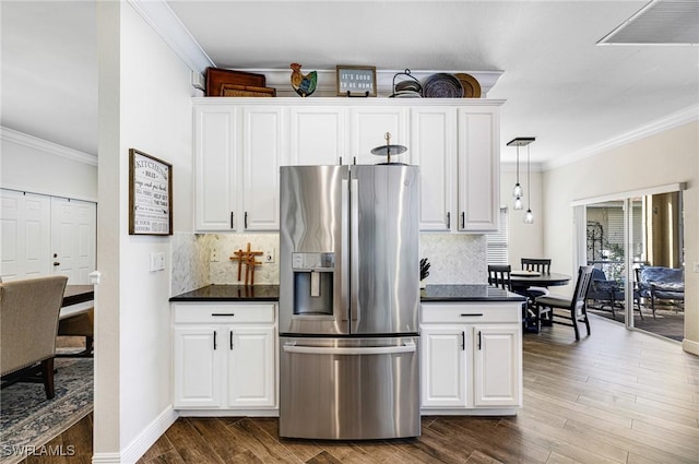 kitchen with decorative light fixtures, white cabinets, dark wood-type flooring, and stainless steel fridge with ice dispenser