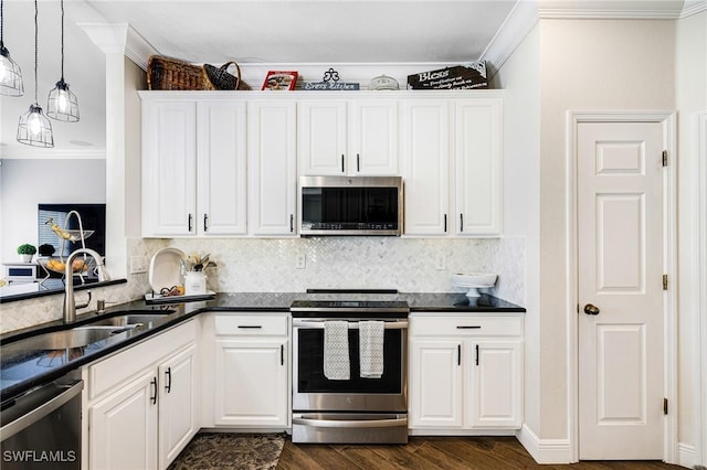 kitchen featuring stainless steel appliances, dark hardwood / wood-style floors, hanging light fixtures, white cabinets, and sink