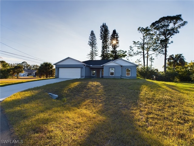 single story home featuring a garage and a front lawn