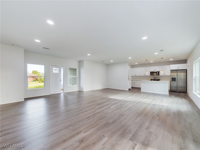 unfurnished living room with light hardwood / wood-style flooring