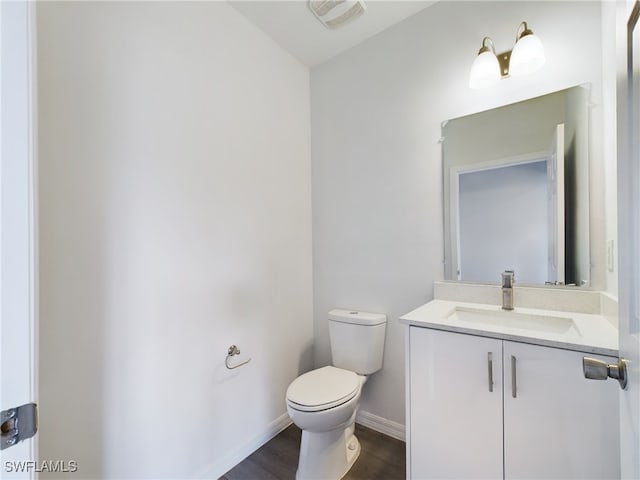 bathroom featuring hardwood / wood-style floors, vanity, and toilet