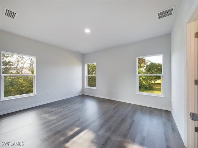 unfurnished room featuring dark hardwood / wood-style floors