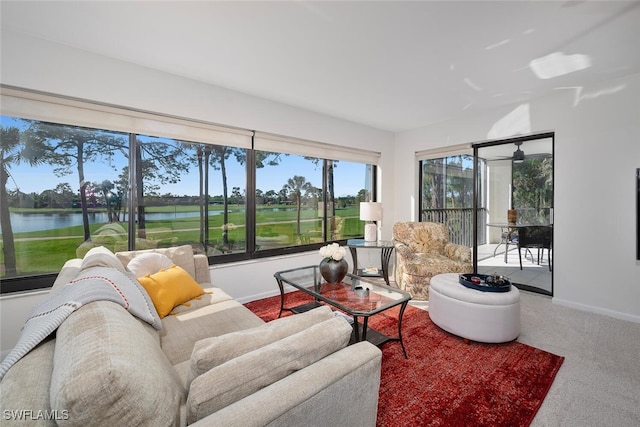 carpeted living room with a water view