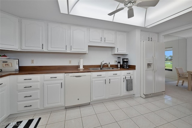 kitchen with wood counters, white appliances, white cabinets, sink, and ceiling fan