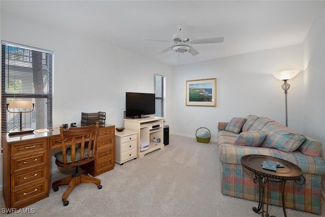 carpeted office space with ceiling fan