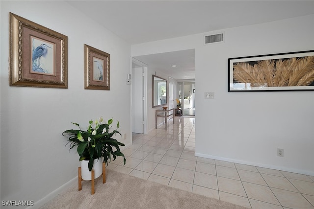 hall with light tile patterned floors