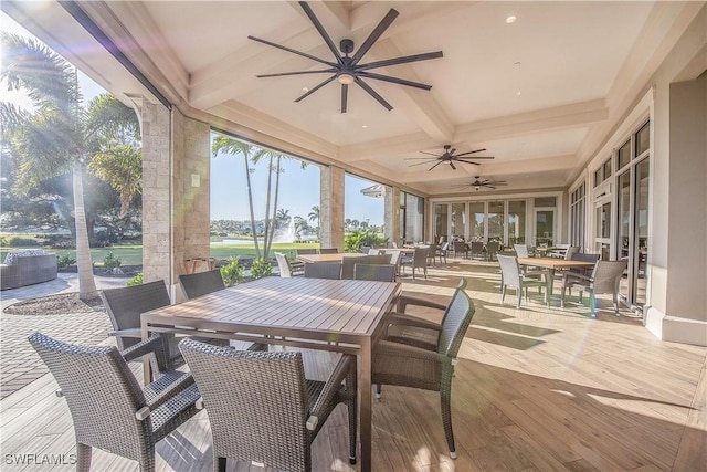 sunroom featuring beam ceiling, ceiling fan, and coffered ceiling