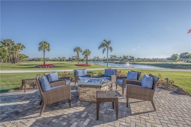 view of patio featuring a water view and a fire pit