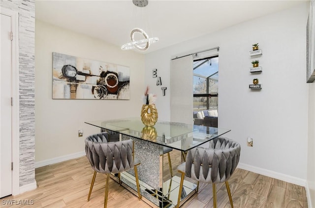 dining room with hardwood / wood-style floors and a chandelier