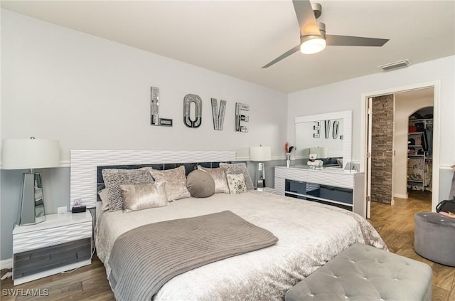 bedroom with ceiling fan and wood-type flooring