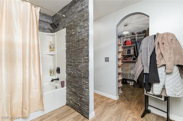 bathroom with shower / tub combo with curtain and hardwood / wood-style flooring