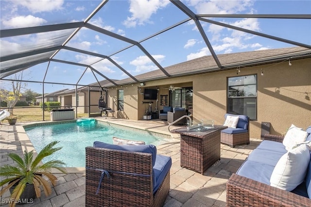 view of pool featuring a lanai, a patio area, ceiling fan, and outdoor lounge area