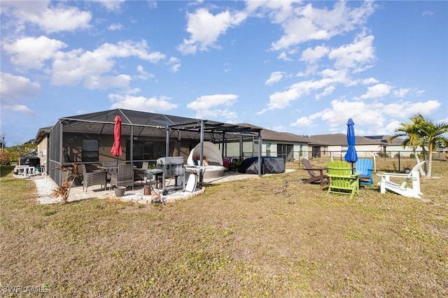 exterior space featuring a patio area, a lanai, and a lawn