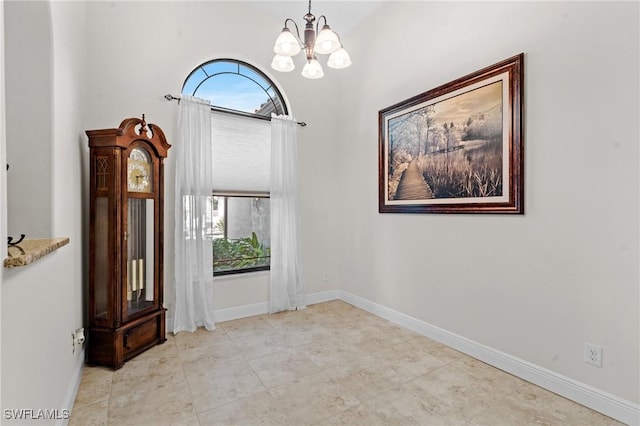 empty room featuring a chandelier