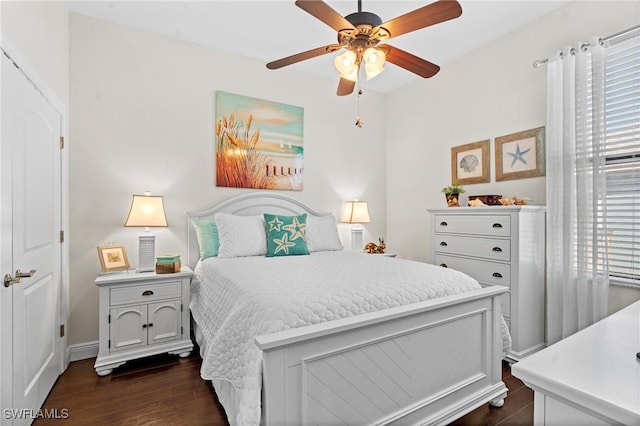 bedroom with dark hardwood / wood-style floors and ceiling fan