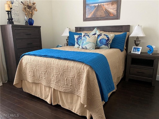 bedroom with dark wood-type flooring