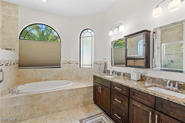 bathroom with vanity, plus walk in shower, and tile patterned flooring