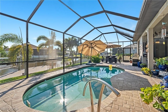 view of pool featuring a patio and glass enclosure