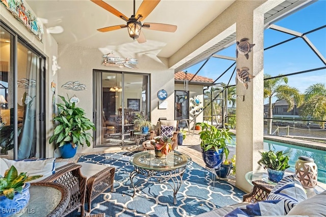 sunroom featuring ceiling fan