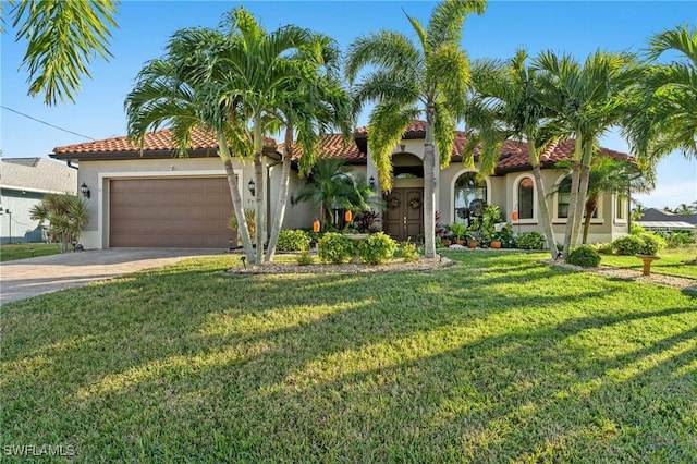 mediterranean / spanish home with a garage and a front lawn