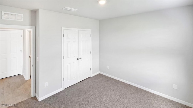 unfurnished bedroom with carpet flooring and a closet