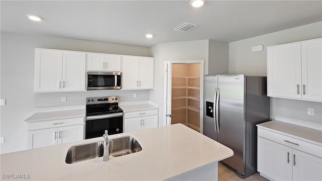 kitchen featuring sink, white cabinetry, and stainless steel appliances