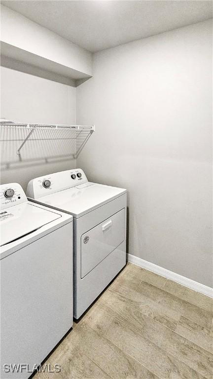 clothes washing area featuring separate washer and dryer