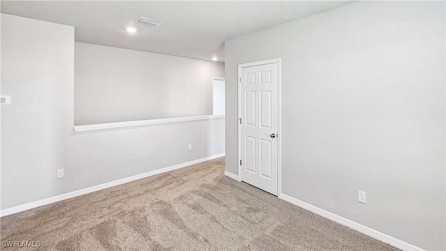 empty room with light colored carpet