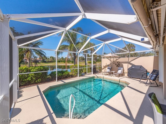 view of swimming pool featuring a water view, a patio area, grilling area, and a lanai