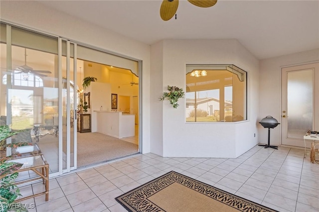 interior space with ceiling fan and a patio