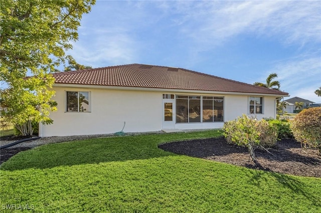 back of house with a lawn