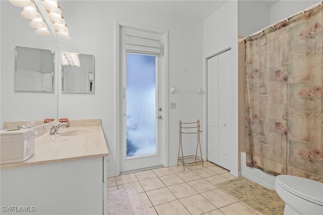 full bathroom featuring tile patterned flooring, vanity, toilet, and shower / tub combo with curtain