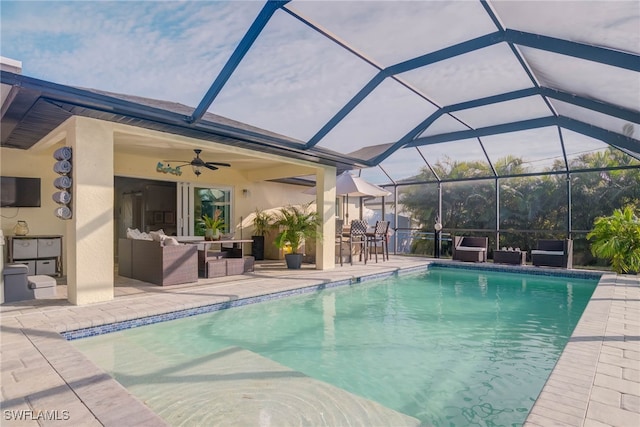 view of pool with a lanai, outdoor lounge area, ceiling fan, and a patio area